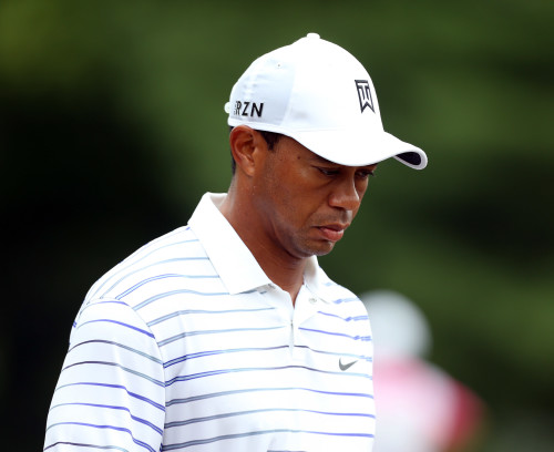Aug 8, 2014; Louisville, KY, USA; PGA golfer Tiger Woods reacts as he walks down a fairway during the second round of the 2014 PGA Championship golf tournament at Valhalla Golf Club. Mandatory Credit: Brian Spurlock-USA TODAY Sports