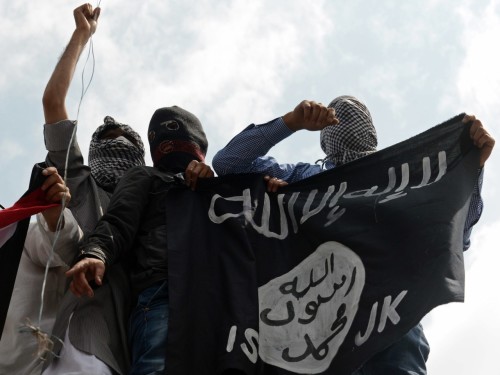 Kashmiri demonstrators hold up a flag of the Islamic State of Iraq and the Levant (ISIL) during a demonstration against Israeli military operations in Gaza, in downtown Srinagar on July 18, 2014. The death toll in Gaza hit 265 as Israel pressed a ground offensive on the 11th day of an assault aimed at stamping out rocket fire, medics said. AFP PHOTO/Tauseef MUSTAFA (Photo credit should read TAUSEEF MUSTAFA/AFP/Getty Images)